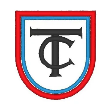 Escudo bordado del Colegio Terra Nova en rojo, azul y negro.